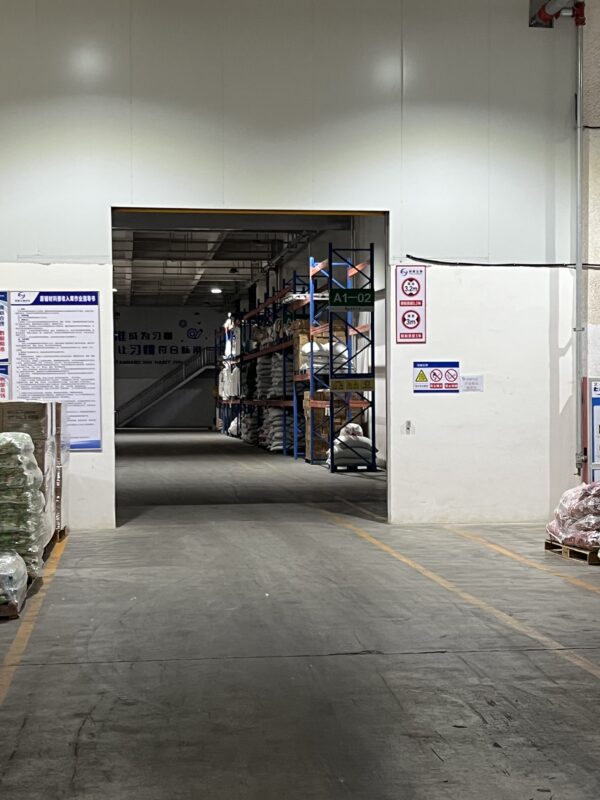 Warehouse area with storage racks and packed goods at Pet Secret's Shandong facility